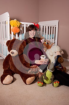 Pregnant woman with stuffed toys