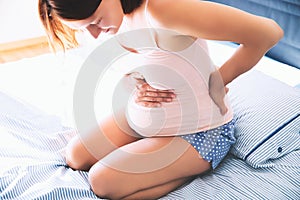 Pregnant woman suffering lower back pain, backache