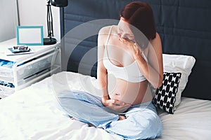 Pregnant woman suffering with nausea photo