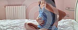 Pregnant woman suffers from lower back pain on bed