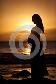 Pregnant woman at sunset