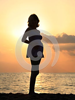 Pregnant woman at sunset