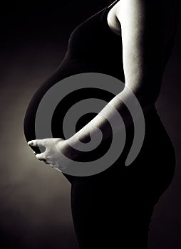 Pregnant Woman Supporting her Belly