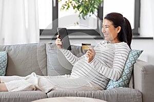 pregnant woman with tablet pc and credit card