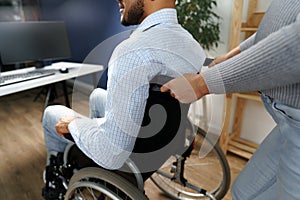 Pregnant woman takes care of her disabled husband in wheelchair