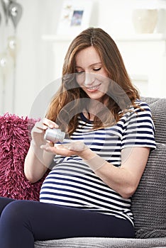 Pregnant Woman Taking Folic Acid Tablets