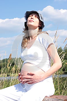 Pregnant woman taking sunbathe