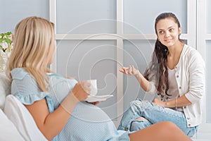 Pregnant woman talking with a friend