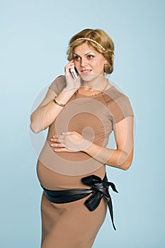 Pregnant woman talking a mobile