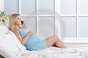Pregnant woman talking on phone