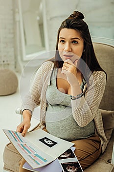 Pregnant woman thinking on the name for her future child