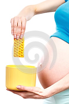 Pregnant woman throwing medical pills or tablets, reduction of using pharmaceuticals in pregnancy