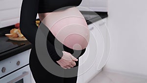 Pregnant woman tightening a belly band
