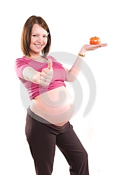 Pregnant woman with a tomato