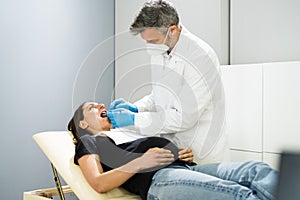 Pregnant Woman Tooth Decay. Dentistry Check By Dentist photo