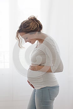 Pregnant woman touching belly