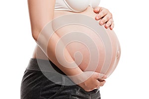 Pregnant woman touching or bonding her abdomen