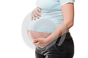 Pregnant woman touching or bonding her abdomen