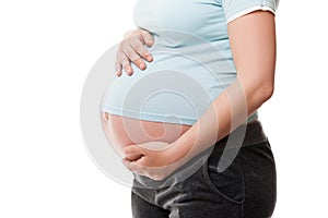 Pregnant woman touching or bonding her abdomen photo