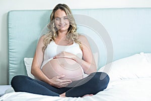 Pregnant woman touching her belly