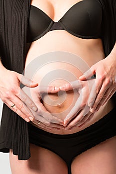 Pregnant woman touching her belly or baby bump