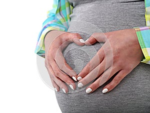 Pregnant woman touching her belly with hands