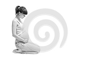 Pregnant woman touching her belly with hands isolated on white