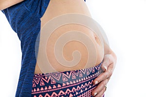 Pregnant woman touching her belly, isolated on white background