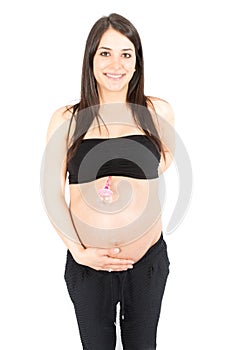 Pregnant woman touching her big belly over white background