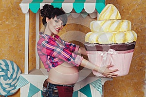 Pregnant woman with toy cake