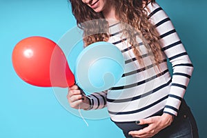 Pregnant woman tries to guess the boy or girl. Balloons as symbol of boy and girl.