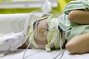 Pregnant woman undergoing cardiotocography