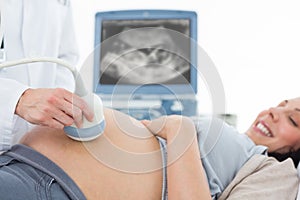 Pregnant woman undergoing ultrasound photo