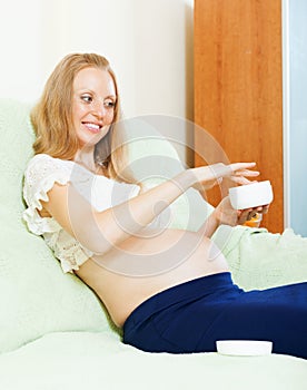 Pregnant woman using cosmetic cream