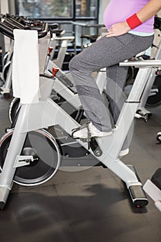 Pregnant woman using exercise bike