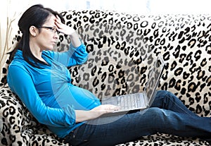 Pregnant woman using laptop