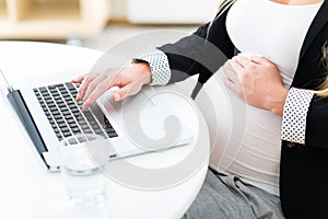 Pregnant woman using laptop