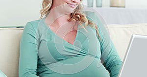 Pregnant woman using laptop