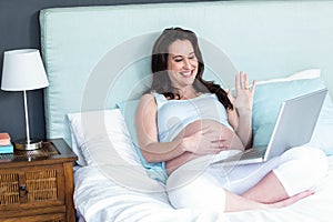 Pregnant woman using laptop