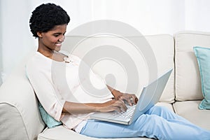 Pregnant woman using laptop