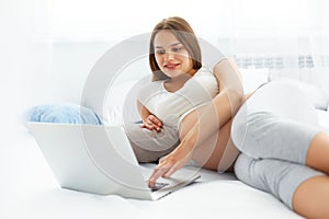 Pregnant Woman Using Laptop Computer