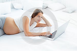 Pregnant Woman Using Laptop Computer