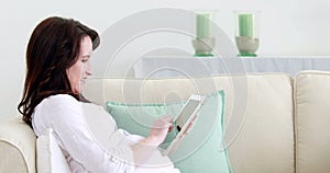 Pregnant woman using tablet