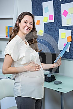 Pregnant woman using tablet