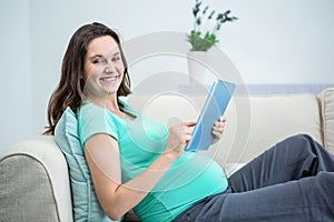 Pregnant woman using tablet