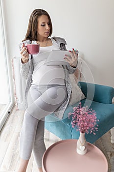 Pregnant woman using a tablet computer