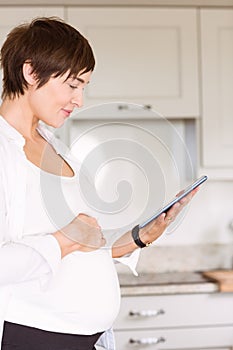 Pregnant woman using tablet pc