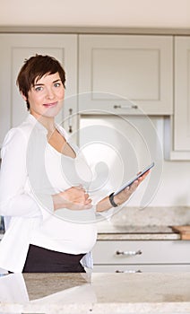 Pregnant woman using tablet pc