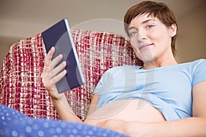 Pregnant woman using tablet pc