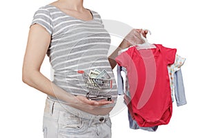 Pregnant woman with various clothes for a newborn